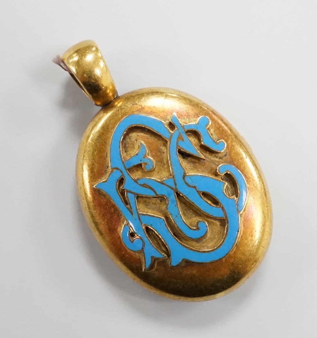 A Victorian yellow metal and enamelled oval locket, 39mm, gross weight 13.2 grams.